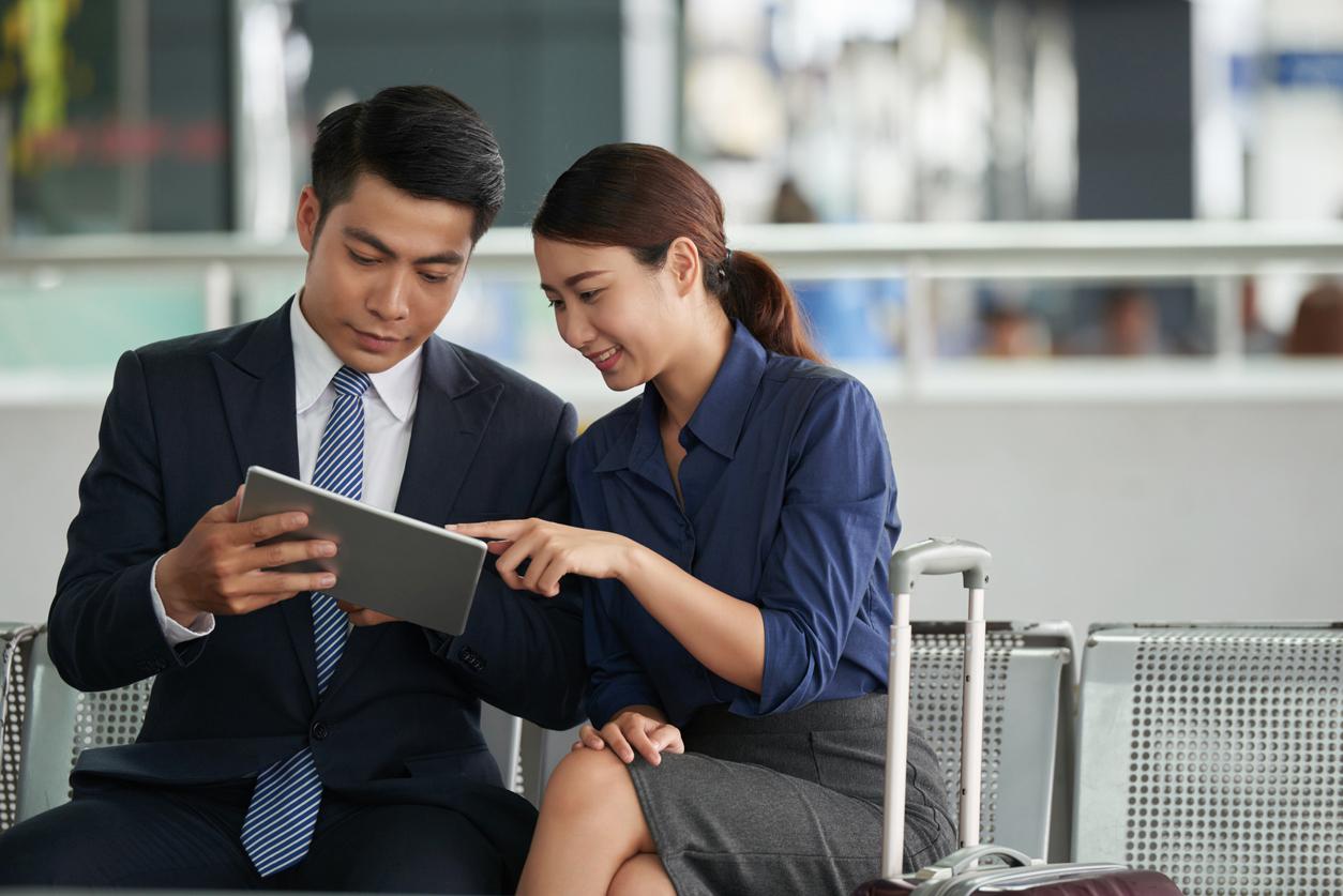 Two people using a tablet while doing business in a Foreign-Trade Zone in Lakewood, WA